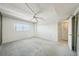 Bedroom with light carpet, ceiling fan, and a window providing natural light at 6020 S Shore Blvd # 709, Gulfport, FL 33707