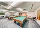 Well-lit game room featuring multiple billiard tables and a shuffleboard, perfect for entertaining and community fun at 6020 S Shore Blvd # 709, Gulfport, FL 33707