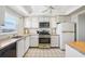 Bright kitchen features white cabinets, stainless steel appliances, and tiled floors for a clean, modern look at 6020 S Shore Blvd # 709, Gulfport, FL 33707