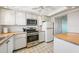 Bright kitchen featuring white cabinetry, stainless steel appliances, and a tile backsplash at 6020 S Shore Blvd # 709, Gulfport, FL 33707