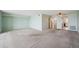 Open living room with light carpet and access to the kitchen and other rooms at 6020 S Shore Blvd # 709, Gulfport, FL 33707