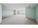 Spacious living room with light carpet, ceiling fan, and windows offering a lovely view at 6020 S Shore Blvd # 709, Gulfport, FL 33707