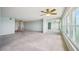 Bright living room with light carpet, ceiling fan, and multiple windows offering a lovely view at 6020 S Shore Blvd # 709, Gulfport, FL 33707