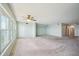 Bright living room with light carpet, ceiling fan, and large windows offering a lovely view at 6020 S Shore Blvd # 709, Gulfport, FL 33707