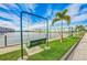 Scenic waterfront view with a swing set, palm trees, and well-maintained green space at 6020 S Shore Blvd # 709, Gulfport, FL 33707