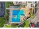 Birds eye view of two interlocked pools, blue lounge furniture, shaded umbrellas and green shrubbery at 6020 S Shore Blvd # 709, Gulfport, FL 33707