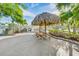 Charming tiki hut with picnic table in a tropical setting, providing a relaxing space for outdoor gatherings and enjoyment at 6020 S Shore Blvd # 709, Gulfport, FL 33707