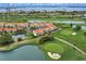 Aerial view showcasing lush golf course, serene lakes, and beautiful residential buildings in a waterfront community at 6131 Bahia Del Mar Blvd # 241, St Petersburg, FL 33715