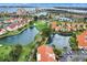 Panoramic aerial shot showcasing a waterfront community featuring golf courses, lakes, and residential buildings at 6131 Bahia Del Mar Blvd # 241, St Petersburg, FL 33715