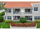 Backside of unit showcasing ground floor patio and second story balconies overlooking manicured landscaping at 6131 Bahia Del Mar Blvd # 241, St Petersburg, FL 33715