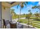 Balcony seating overlooks lush golf course views, offering a serene outdoor space with palm tree accents at 6131 Bahia Del Mar Blvd # 241, St Petersburg, FL 33715