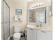 This bathroom boasts a modern sink, shower with glass door, and beach-themed wall decor for a relaxing ambiance at 6131 Bahia Del Mar Blvd # 241, St Petersburg, FL 33715