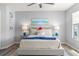 Inviting bedroom with a cozy bed, side tables, a lake view, and light-colored wood-look floors at 6131 Bahia Del Mar Blvd # 241, St Petersburg, FL 33715