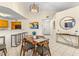 Charming dining area with modern lighting and bar seating near the kitchen at 6131 Bahia Del Mar Blvd # 241, St Petersburg, FL 33715