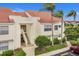 Exterior shot of building featuring stairs leading to units, complemented by manicured landscaping at 6131 Bahia Del Mar Blvd # 241, St Petersburg, FL 33715