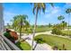 Scenic golf course view from balcony features lush greenery, palm trees, and serene landscaping at 6131 Bahia Del Mar Blvd # 241, St Petersburg, FL 33715