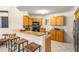Bright kitchen with granite countertops, wood cabinets, and bar seating at 6131 Bahia Del Mar Blvd # 241, St Petersburg, FL 33715