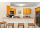 Bright kitchen with bar, black appliances, and granite countertops at 6131 Bahia Del Mar Blvd # 241, St Petersburg, FL 33715