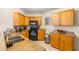 Well-lit kitchen with black appliances and granite countertops at 6131 Bahia Del Mar Blvd # 241, St Petersburg, FL 33715