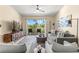 Inviting living room with modern decor, plush seating, and a sliding glass door to balcony with golf course views at 6131 Bahia Del Mar Blvd # 241, St Petersburg, FL 33715