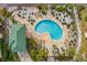 A high angle view of the private community pool, complete with lounge seating and landscaping at 6319 Sunset Bay Cir, Apollo Beach, FL 33572