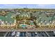Stunning aerial view of waterfront condos, pool, and boat docks in a lush tropical setting at 6319 Sunset Bay Cir, Apollo Beach, FL 33572
