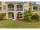 Back of building showing patios, lush backyard, and water view at 6319 Sunset Bay Cir, Apollo Beach, FL 33572