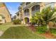 Backyard view with lush greenery, screened balcony, and patio with umbrella at 6319 Sunset Bay Cir, Apollo Beach, FL 33572