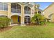 Backyard view with screened balcony and outdoor patio with an umbrella at 6319 Sunset Bay Cir, Apollo Beach, FL 33572