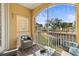 Relaxing screened-in balcony with comfortable outdoor seating and views of the landscaped community at 6319 Sunset Bay Cir, Apollo Beach, FL 33572