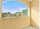 Balcony overlooking manicured landscaping and buildings with bright green roofs at 6319 Sunset Bay Cir, Apollo Beach, FL 33572