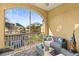 Relaxing screened-in balcony with comfortable outdoor seating and views of the landscaped community at 6319 Sunset Bay Cir, Apollo Beach, FL 33572