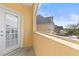 Cozy balcony looking out onto neighborhood homes and clear, blue sky at 6319 Sunset Bay Cir, Apollo Beach, FL 33572