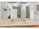 Bathroom featuring double sinks with a large mirror, and a separate shower in the background at 6319 Sunset Bay Cir, Apollo Beach, FL 33572
