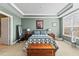 Comfortable bedroom features a large window, stylish decor, and ample space for relaxation and personalization at 6319 Sunset Bay Cir, Apollo Beach, FL 33572