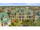Bright yellow townhome exterior featuring charming balconies and lush landscaping in a well-maintained community at 6319 Sunset Bay Cir, Apollo Beach, FL 33572