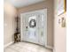 Welcoming foyer with decorative glass front door and neutral tile flooring at 6319 Sunset Bay Cir, Apollo Beach, FL 33572