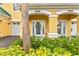 Charming front door with decorative wreath, glass accents, and vibrant, well-maintained landscaping at 6319 Sunset Bay Cir, Apollo Beach, FL 33572