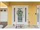 Inviting entryway features a decorative wreath, glass accents, and a charming flamingo, adding a touch of personality at 6319 Sunset Bay Cir, Apollo Beach, FL 33572