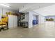 Spacious garage with epoxy flooring, storage cabinets, and access to the outdoors at 6319 Sunset Bay Cir, Apollo Beach, FL 33572