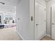 Hallway leading to a living area with a desk, a chair, and large windows at 6319 Sunset Bay Cir, Apollo Beach, FL 33572