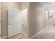 Hallway with a door leading to the carpeted stairs at 6319 Sunset Bay Cir, Apollo Beach, FL 33572