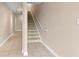 Hallway with tiled floor and carpeted stairs at 6319 Sunset Bay Cir, Apollo Beach, FL 33572