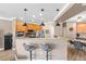 Open kitchen featuring stainless steel appliances, granite countertops, a breakfast bar, and modern pendant lighting at 6319 Sunset Bay Cir, Apollo Beach, FL 33572