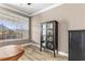 Bright living room features a cabinet and large windows with blinds at 6319 Sunset Bay Cir, Apollo Beach, FL 33572