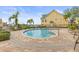 A beautiful community pool is available to residents with lounge seating and tropical landscaping at 6319 Sunset Bay Cir, Apollo Beach, FL 33572