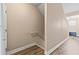 Lower level staircase features wood-look flooring at the base and neutral wall color, leading to carpeted stairs at 6319 Sunset Bay Cir, Apollo Beach, FL 33572