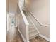 Carpeted staircase featuring a railing that goes to the second floor at 6319 Sunset Bay Cir, Apollo Beach, FL 33572