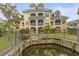Back of building showing patios and lush backyard with water view at 6319 Sunset Bay Cir, Apollo Beach, FL 33572