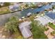 Aerial view of a waterfront property with boat docks, lush greenery, and canal access at 6914 Harbor Dr, Hudson, FL 34667